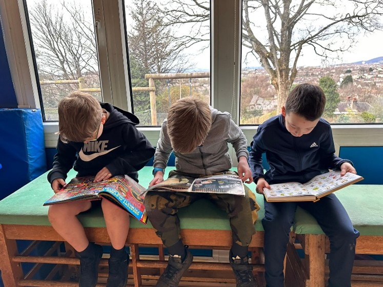 three boys reading